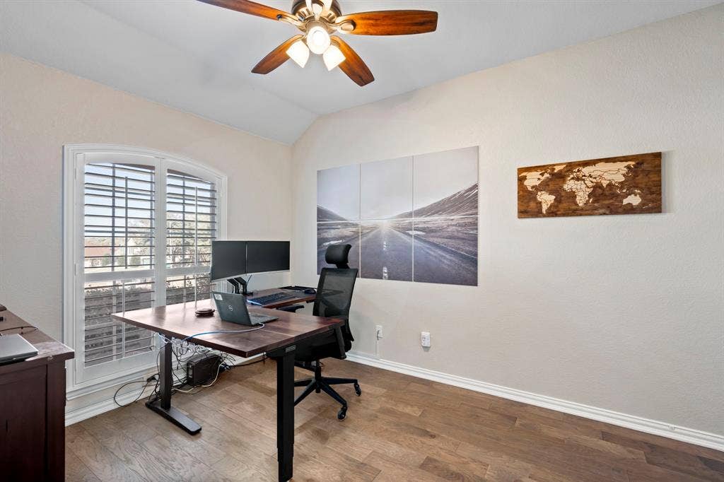 11701 Cambria Court, Fort Worth, TX 76008 Vaulted ceiling with a ceiling fan, wood-finish flooring, and arched window with plantation shutters