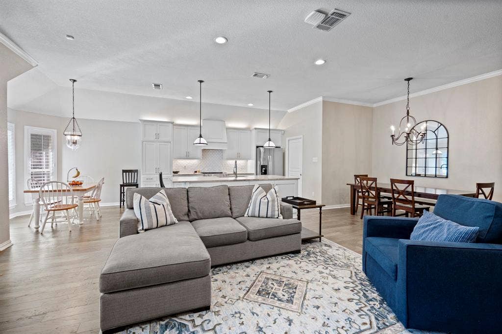11701 Cambria Court, Fort Worth, TX 76008 Open-concept living area featuring wood-finish flooring and recessed lighting
