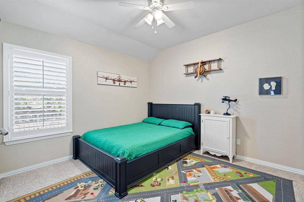 11701 Cambria Court, Fort Worth, TX 76008 Textured walls, ceiling fan, window with plantation shutters, carpeting, and crown molding