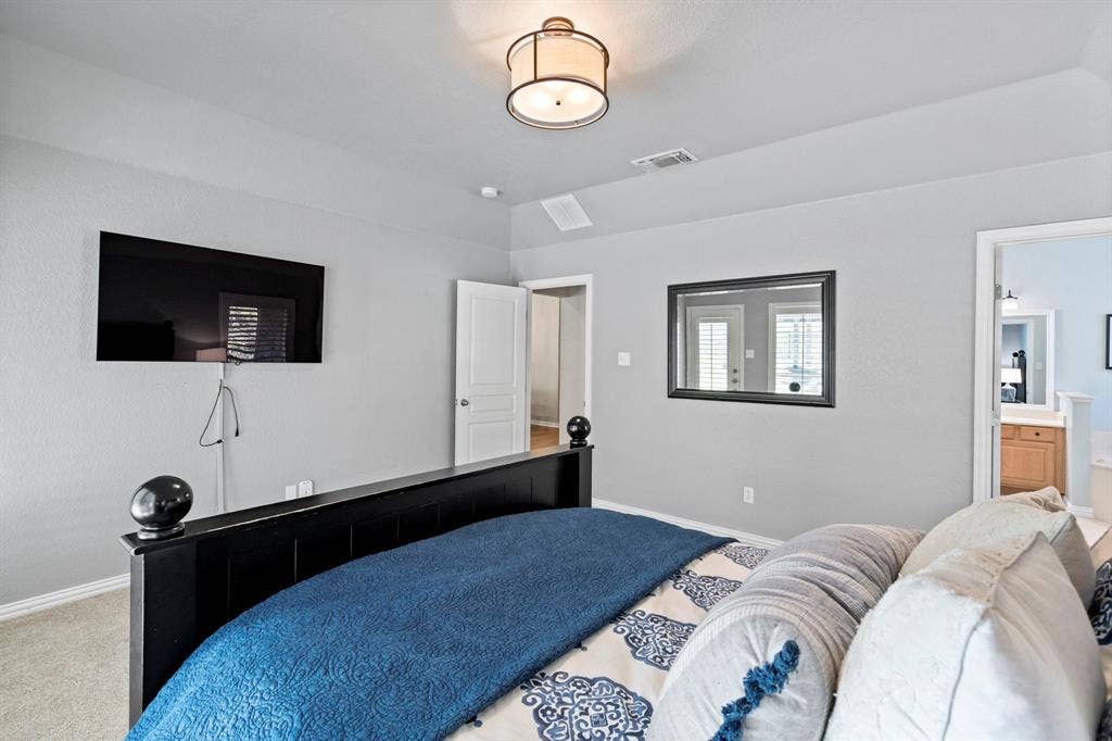 11701 Cambria Court, Fort Worth, TX 76008 Recessed ceiling light fixture, wall-mounted television, and neutral wall paint