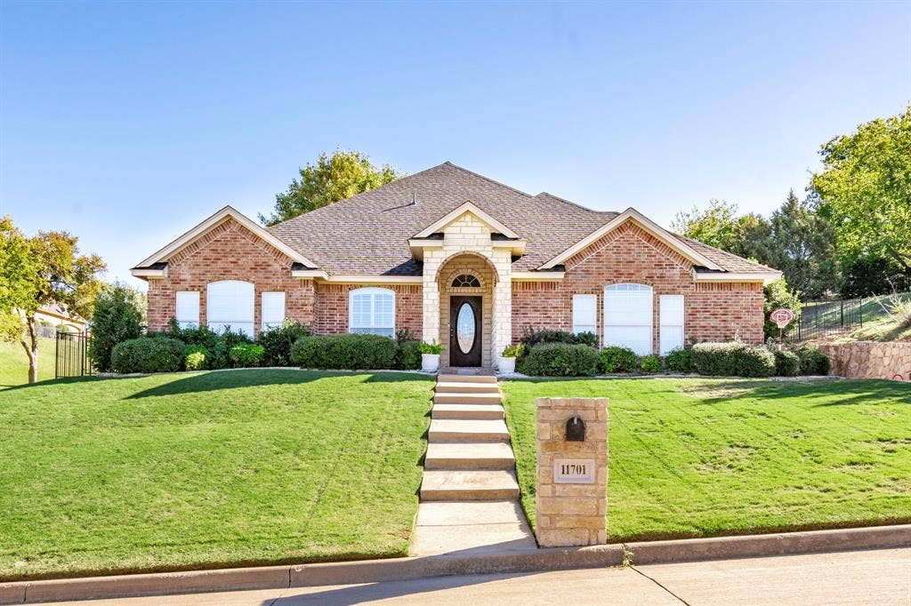 11701 Cambria Court, Fort Worth, TX 76008 Brick and stone facade with arched entry