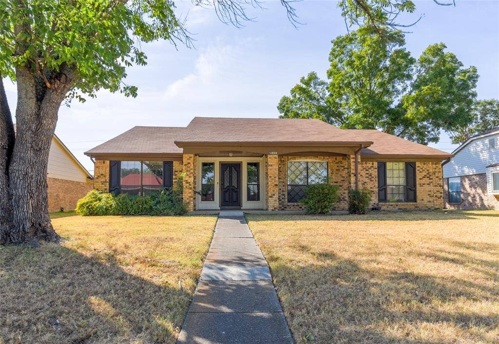 1328 Colmar Drive, Plano, TX 75023 Brick facade, covered front entry, sidewalk leading to the front door, mature trees, contrasting window shutters