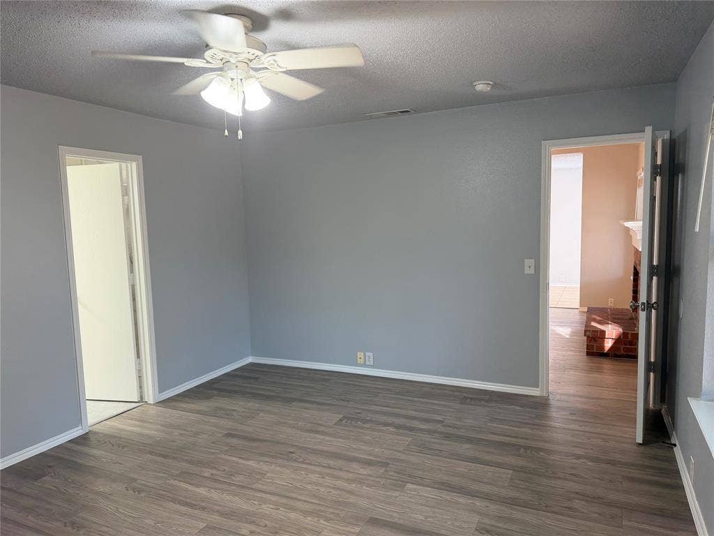 Wood-finish flooring with light gray walls and white trim