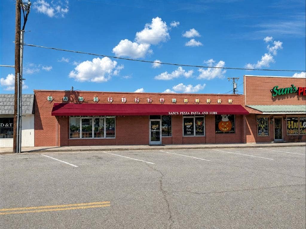 607 Cedar Street, Cedar Hill, TX 75104 Brick exterior with a prominent red awning, large storefront windows, and dedicated front parking