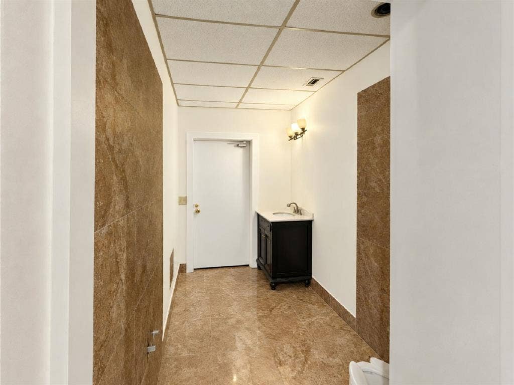 607 Cedar Street, Cedar Hill, TX 75104 Hallway with full height stone-look wall panels and coordinating floor tiles