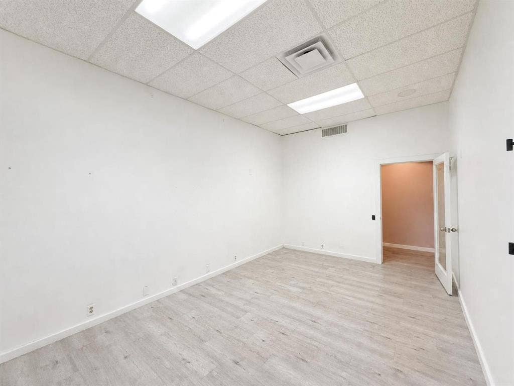 607 Cedar Street, Cedar Hill, TX 75104 Wood-finish flooring, white walls, drop ceiling, recessed lighting, and glass-paneled interior door