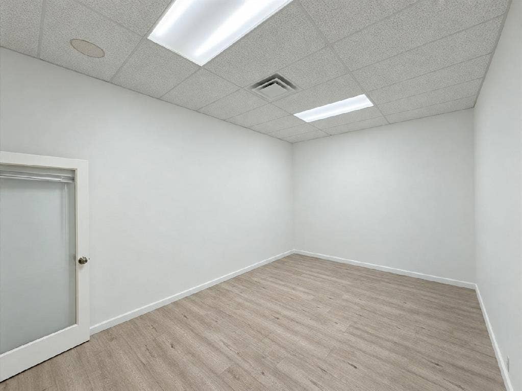 607 Cedar Street, Cedar Hill, TX 75104 Wood-finish flooring, white walls, and a suspended ceiling with recessed lighting and a ventilation register