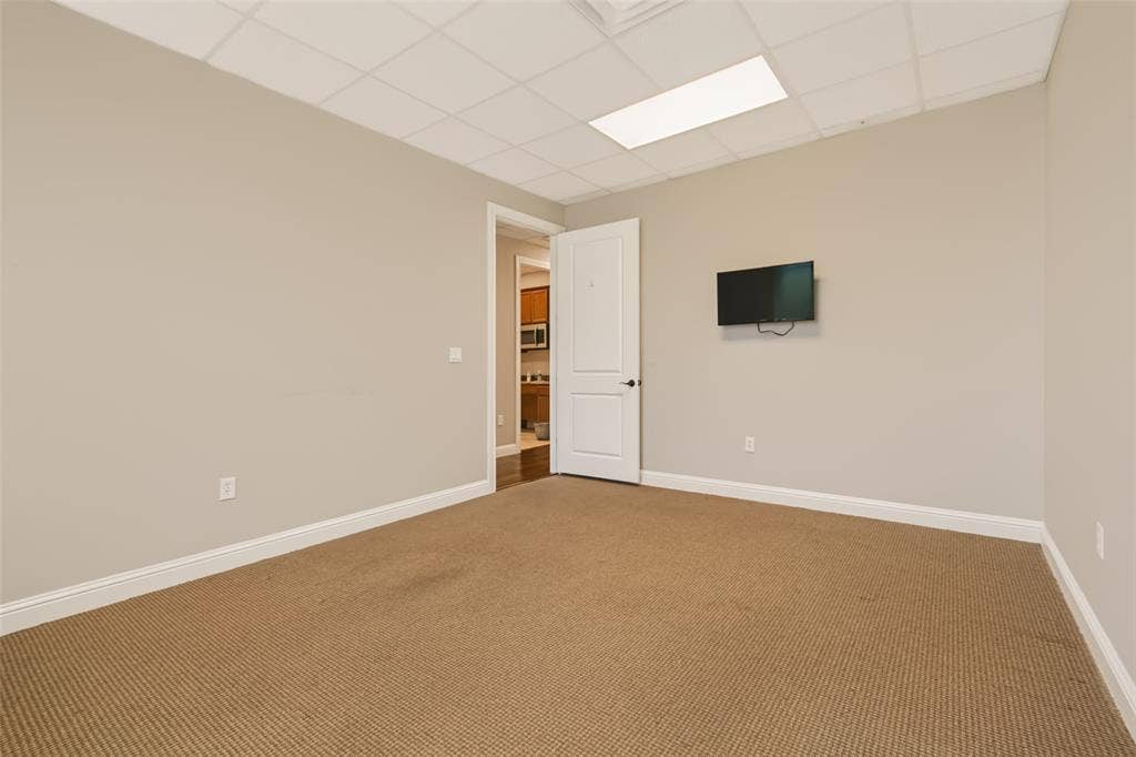 3900 S Stonebridge Drive, #203, McKinney, TX 75070 Neutral wall paint, drop ceiling with recessed lighting, and wall-to-wall carpeting