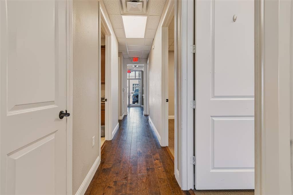 3900 S Stonebridge Drive, #203, McKinney, TX 75070 Hallway featuring wood-finish flooring, white paneled doors, and recessed lighting