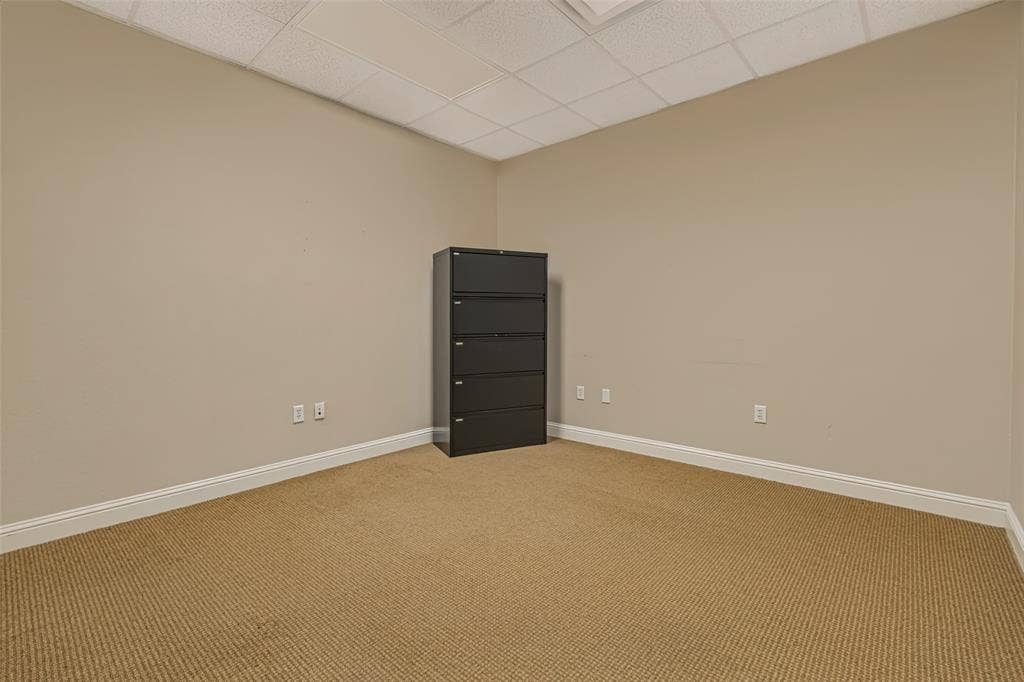 3900 S Stonebridge Drive, #203, McKinney, TX 75070 Neutral wall tones and textured carpet flooring