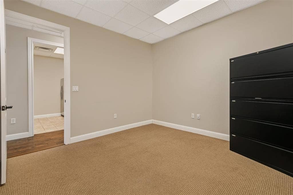 3900 S Stonebridge Drive, #203, McKinney, TX 75070 Neutral wall paint, drop ceiling with integrated lighting, and carpeted flooring