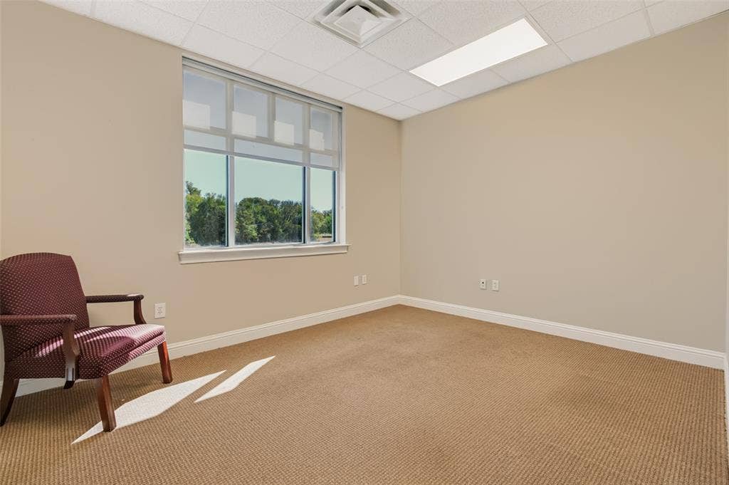 3900 S Stonebridge Drive, #203, McKinney, TX 75070 Neutral-toned walls complement the carpeted flooring
