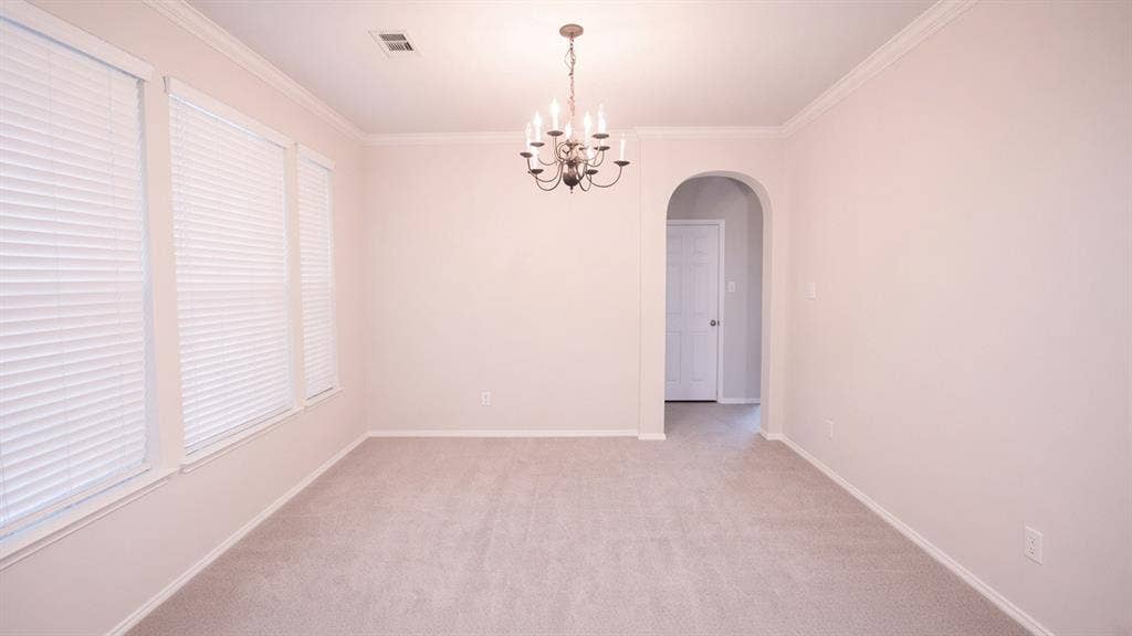 11398 Seguin Drive, Frisco, TX 75035 Room featuring light-toned carpeting, multiple windows with blinds, crown molding, and a chandelier