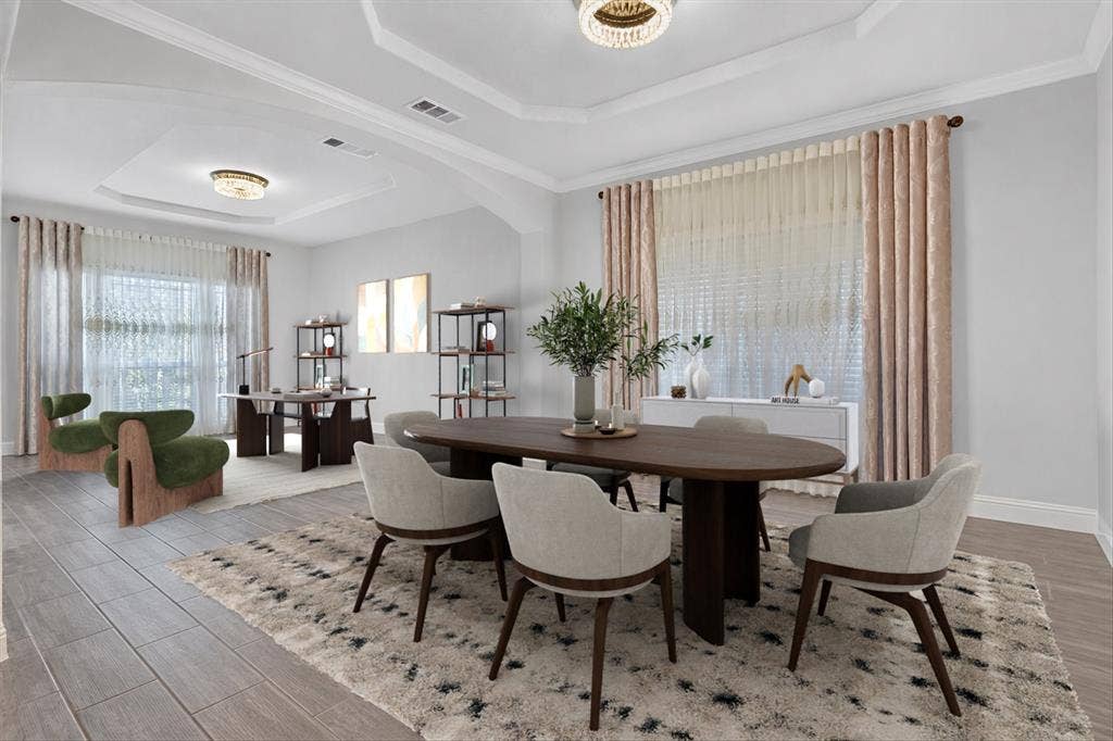 Tray ceiling with a decorative light fixture, wood-finish flooring, and crown molding. Furniture has been virtually staged.