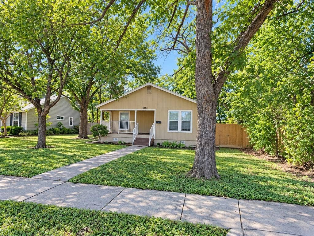 1203 N College Street, McKinney, TX 75069 Single-story residence featuring a covered front porch, white railings, and a light-colored exterior
