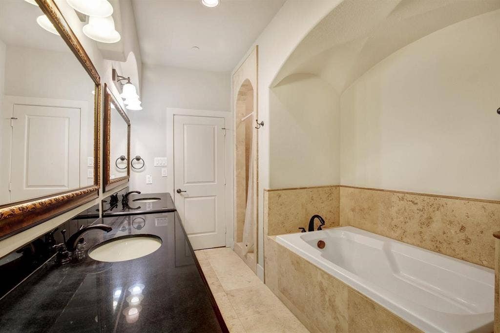 Dual vanity with dark stone-finish countertop