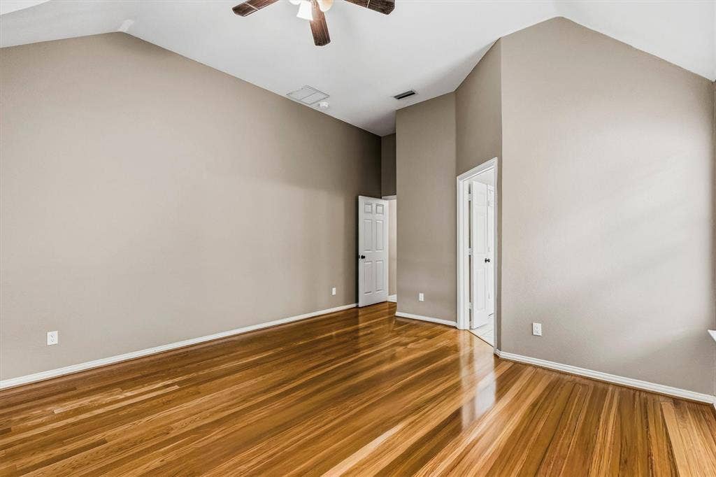 3916 Montrose Drive, Plano, TX 75025 Vaulted ceiling with a ceiling fan, light wood-finish flooring, and neutral wall paint