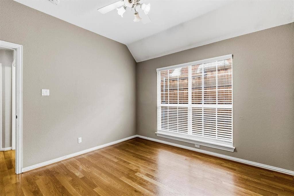 3916 Montrose Drive, Plano, TX 75025 Hardwood-finish flooring, vaulted ceiling, and window with horizontal blinds