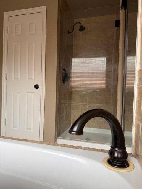 3916 Montrose Drive, Plano, TX 75025 Tub with oil-rubbed bronze faucet and a tiled shower with glass enclosure