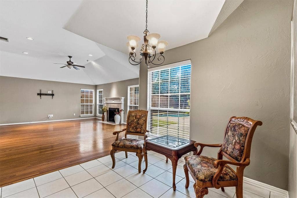 3916 Montrose Drive, Plano, TX 75025 Vaulted ceiling with a ceiling fan, recessed lighting, fireplace with mantel, and wood-finish flooring