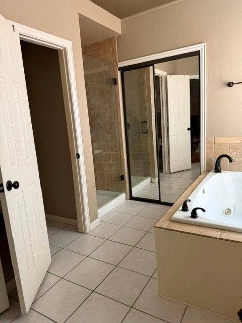 3916 Montrose Drive, Plano, TX 75025 Soaking tub with black fixtures, tiled shower with glass enclosure, and white square tile flooring