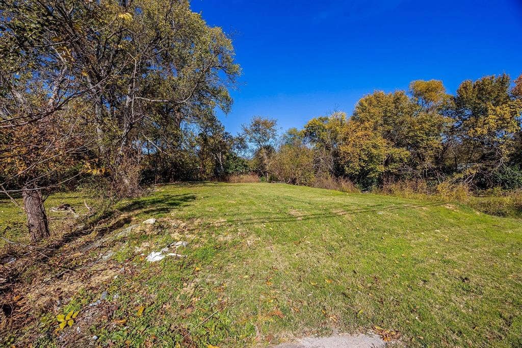 2433 52nd Street, Dallas, TX 75216 Expansive green space with mature trees and a clear sky