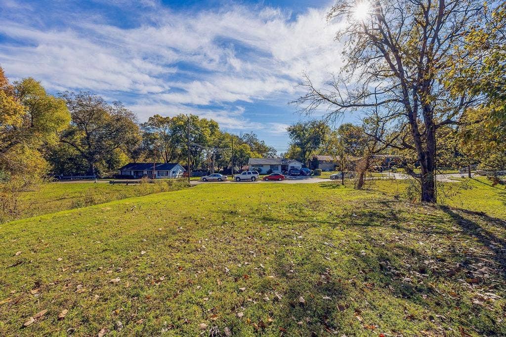 2433 52nd Street, Dallas, TX 75216 Expansive grassy lot featuring mature trees and a sunny disposition