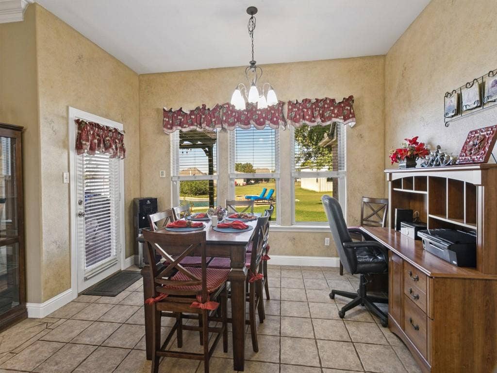 508 Singing Quail Trail, Haslet, TX 76052 Tile flooring, multiple windows, built-in shelving, and a glass-paneled door
