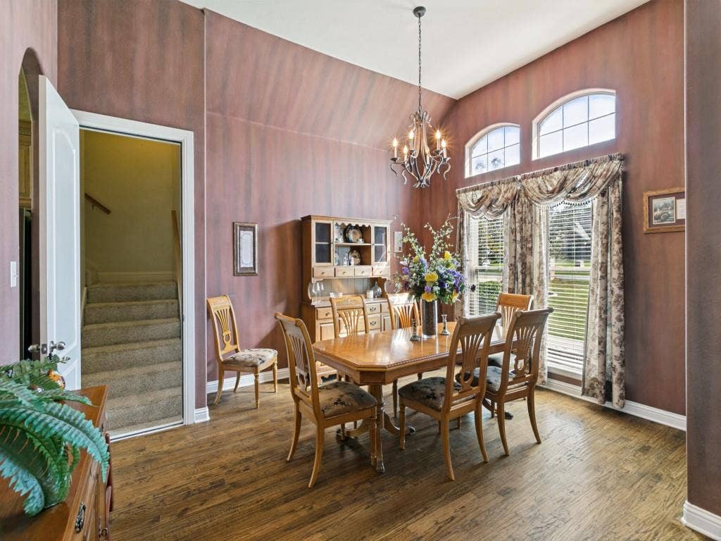 508 Singing Quail Trail, Haslet, TX 76052 Vaulted ceiling, wood-finish flooring, arched windows, chandelier, and a built-in hutch