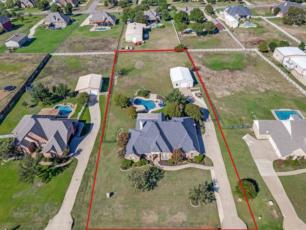508 Singing Quail Trail, Haslet, TX 76052 Expansive property featuring a private swimming pool, detached garage, and a long concrete driveway