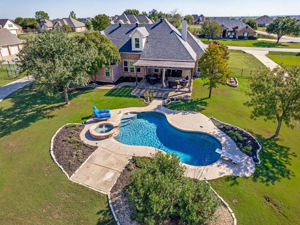 508 Singing Quail Trail, Haslet, TX 76052 Brick exterior with a dark roof and white trim