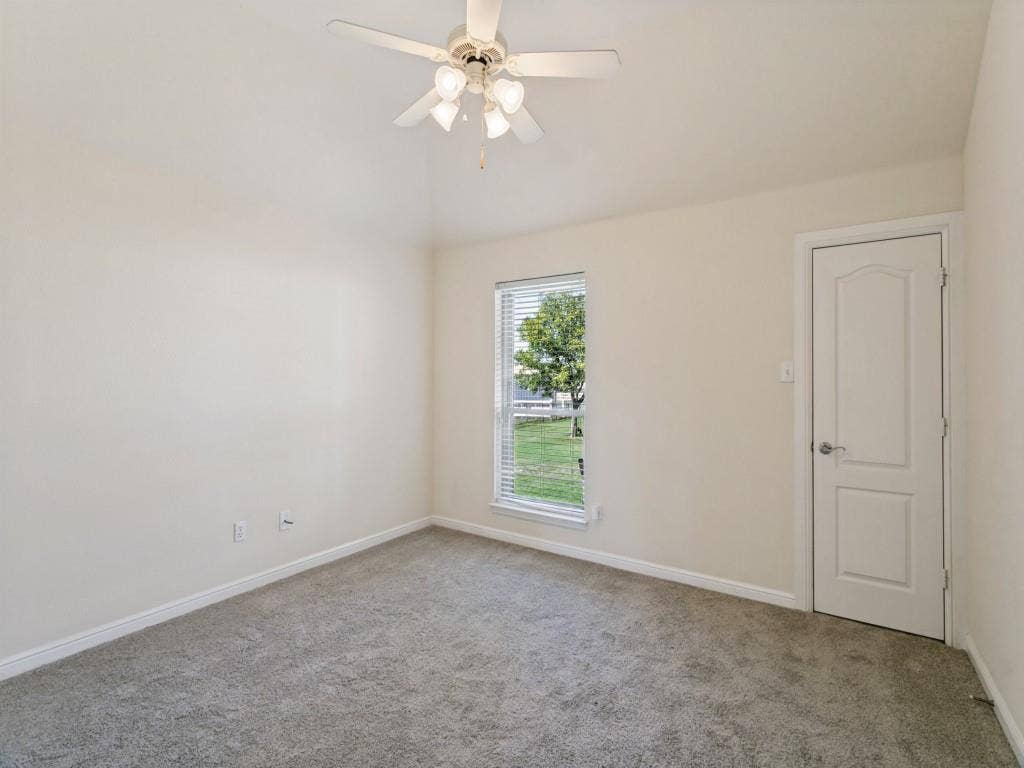 508 Singing Quail Trail, Haslet, TX 76052 Vaulted ceiling with a ceiling fan, carpeted flooring, and a single window with blinds