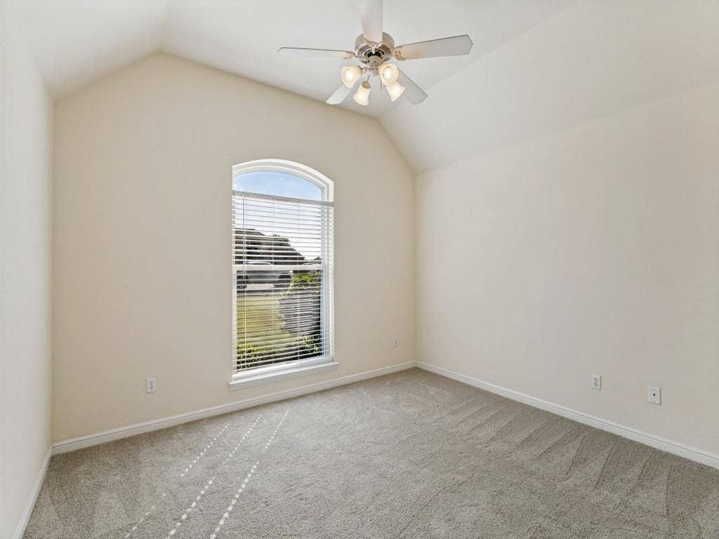 508 Singing Quail Trail, Haslet, TX 76052 Vaulted ceiling featuring a ceiling fan with light kit, arched window with horizontal blinds, and carpeting