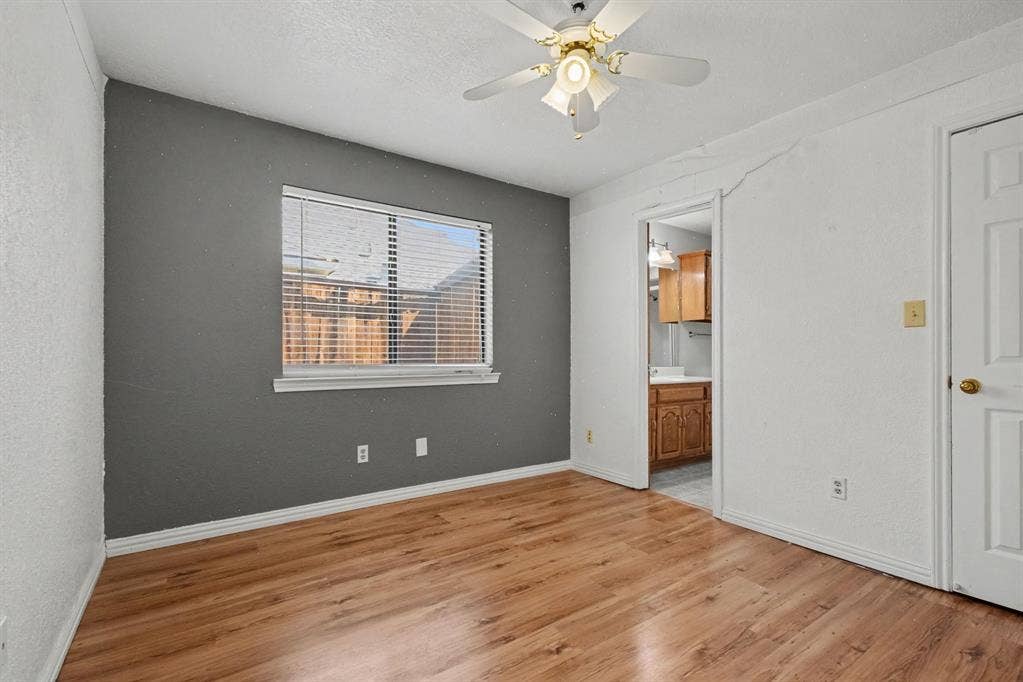 3313 Anchor Drive, Plano, TX 75023 Wood-finish flooring, ceiling fan with integrated lighting, window with blinds, and a white paneled door