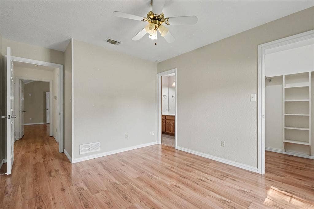 3313 Anchor Drive, Plano, TX 75023 Expansive room with wood-finish flooring, a ceiling fan, and a built-in closet system