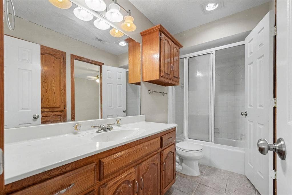 3313 Anchor Drive, Plano, TX 75023 Wood-finish vanity with a white countertop and integrated sink