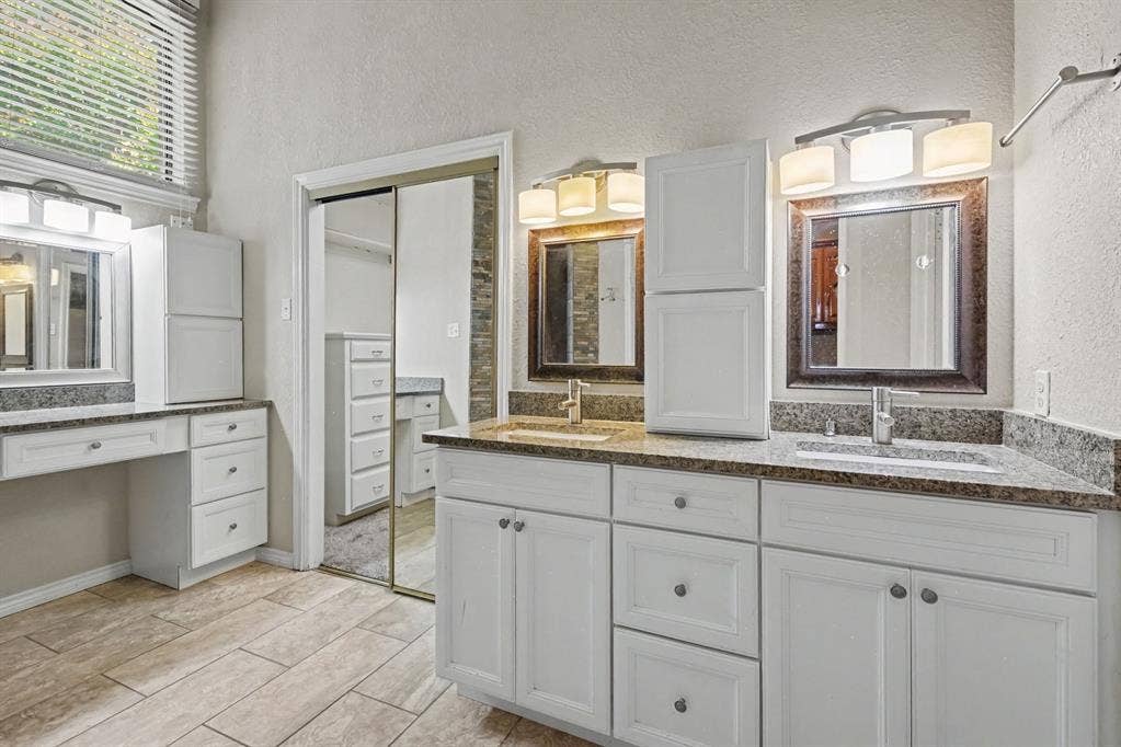 3313 Anchor Drive, Plano, TX 75023 Dual vanity with under-mount sinks, granite-look countertops, and white cabinetry