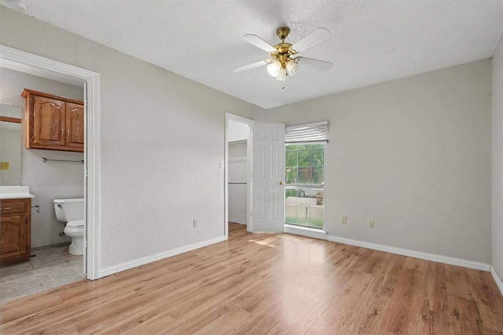 3313 Anchor Drive, Plano, TX 75023 Wood-finish flooring, ceiling fan with integrated lighting, and a white window blind