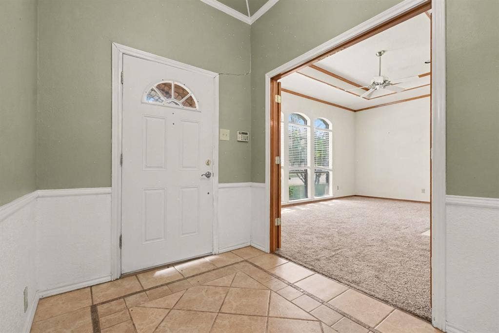 3313 Anchor Drive, Plano, TX 75023 Tiled entry with wainscoting and a vaulted ceiling