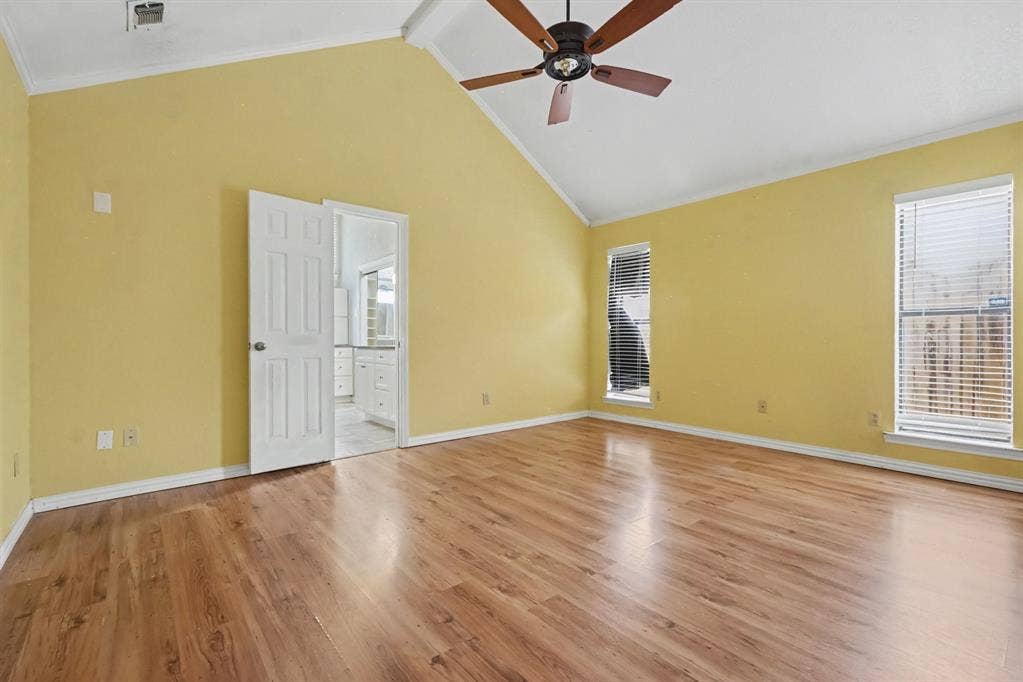 3313 Anchor Drive, Plano, TX 75023 Vaulted ceiling, wood-finish flooring, two windows with blinds, ceiling fan, and white trim