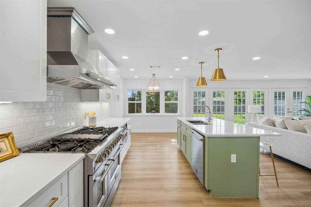 11864 Cold Harbor Lane, Dallas, TX 75244 Updated kitchen with gas range, built in fridge and freezer, and quartz countertops throughout offer both style and function.