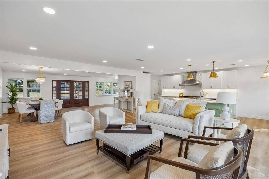 11864 Cold Harbor Lane, Dallas, TX 75244 Expansive open-concept living and dining areas with LVT floors, recessed lighting and seamless flow into the updated kitchen.