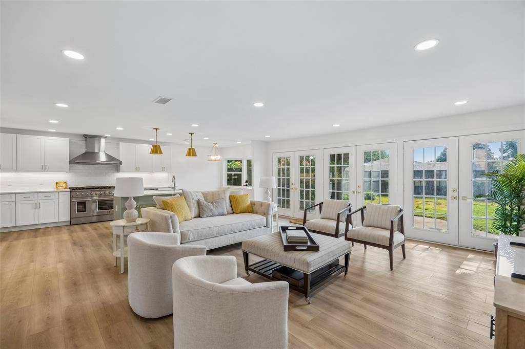 11864 Cold Harbor Lane, Dallas, TX 75244 Open-concept living area with wood floors, abundant natural light and seamless flow into the kitchen and dining spaces.