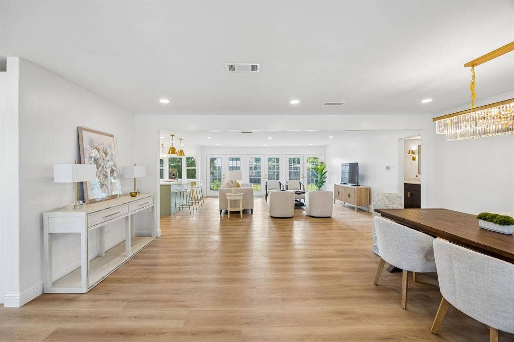 11864 Cold Harbor Lane, Dallas, TX 75244 This open concept great room brings the kitchen, formal dining, breakfast nook, and living area together in one seamless flow. Wood flooring runs throughout, and a neutral color palette lets the space adapt to any style.