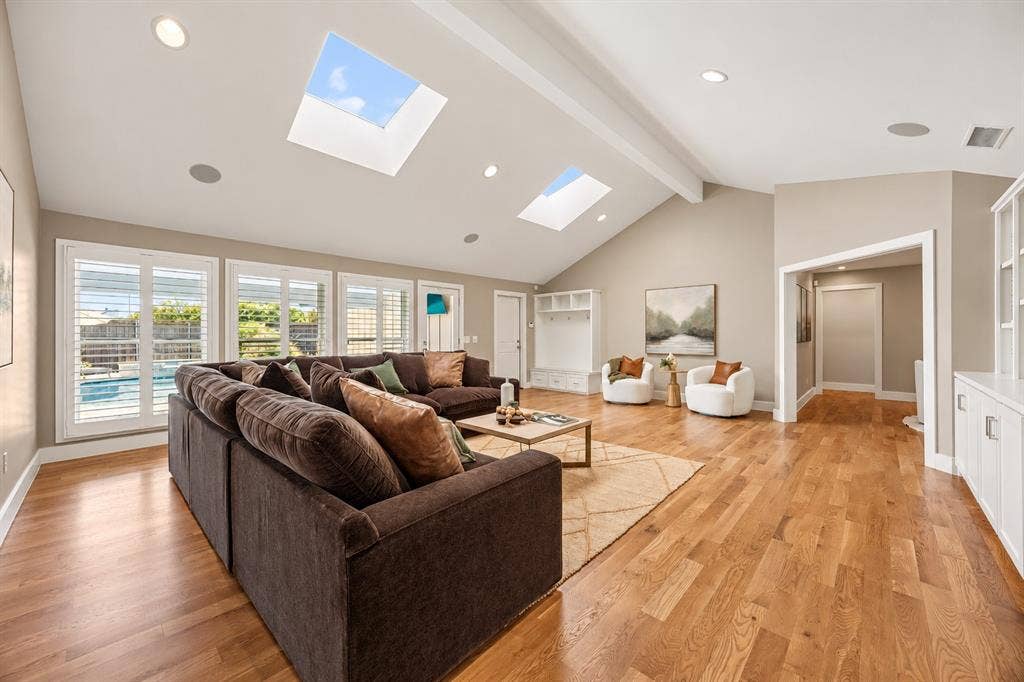 Family room featuring custom storage nook near garage door. Functional and beautiful.