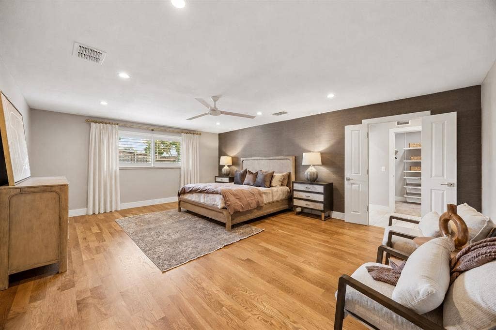 Spacious primary room featuring sitting area and ensuite luxury spa bathroom