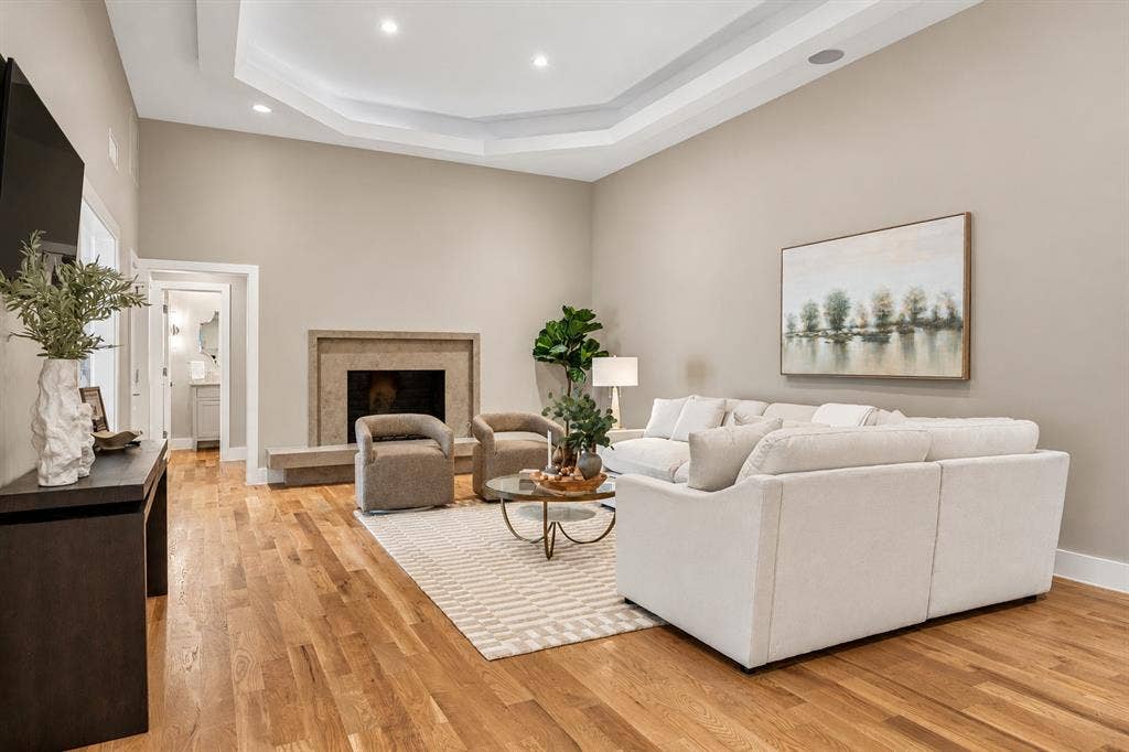 Ambiance lighting, built in-artwork television nook, and custom wood burning gas fireplace