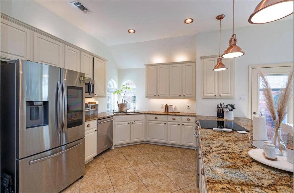 1944 Vantage Drive, Plano, TX 75075 Kitchen featuring granite countertops, tile flooring, white cabinetry, stainless steel appliances, and recessed lighting