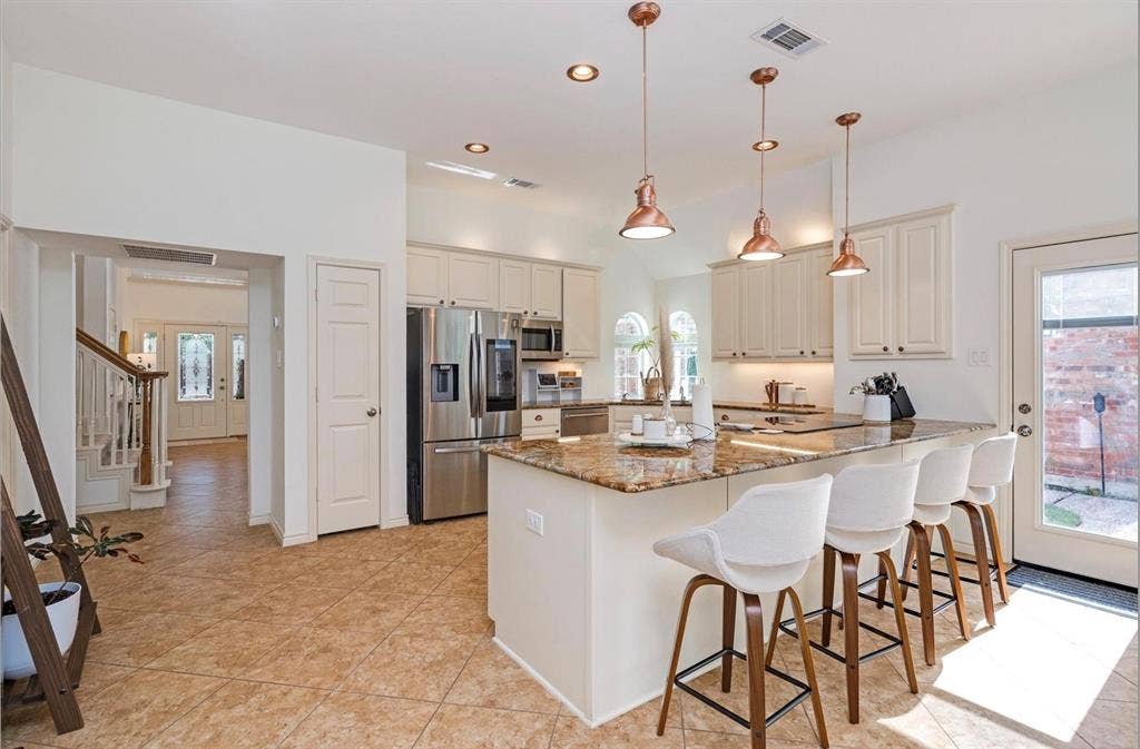 1944 Vantage Drive, Plano, TX 75075 Kitchen with granite-style countertops, stainless steel appliances, recessed lighting, and warm-toned pendant fixtures