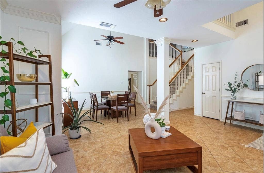 1944 Vantage Drive, Plano, TX 75075 Vaulted ceilings, tile flooring, and a multi-level staircase with wood railings